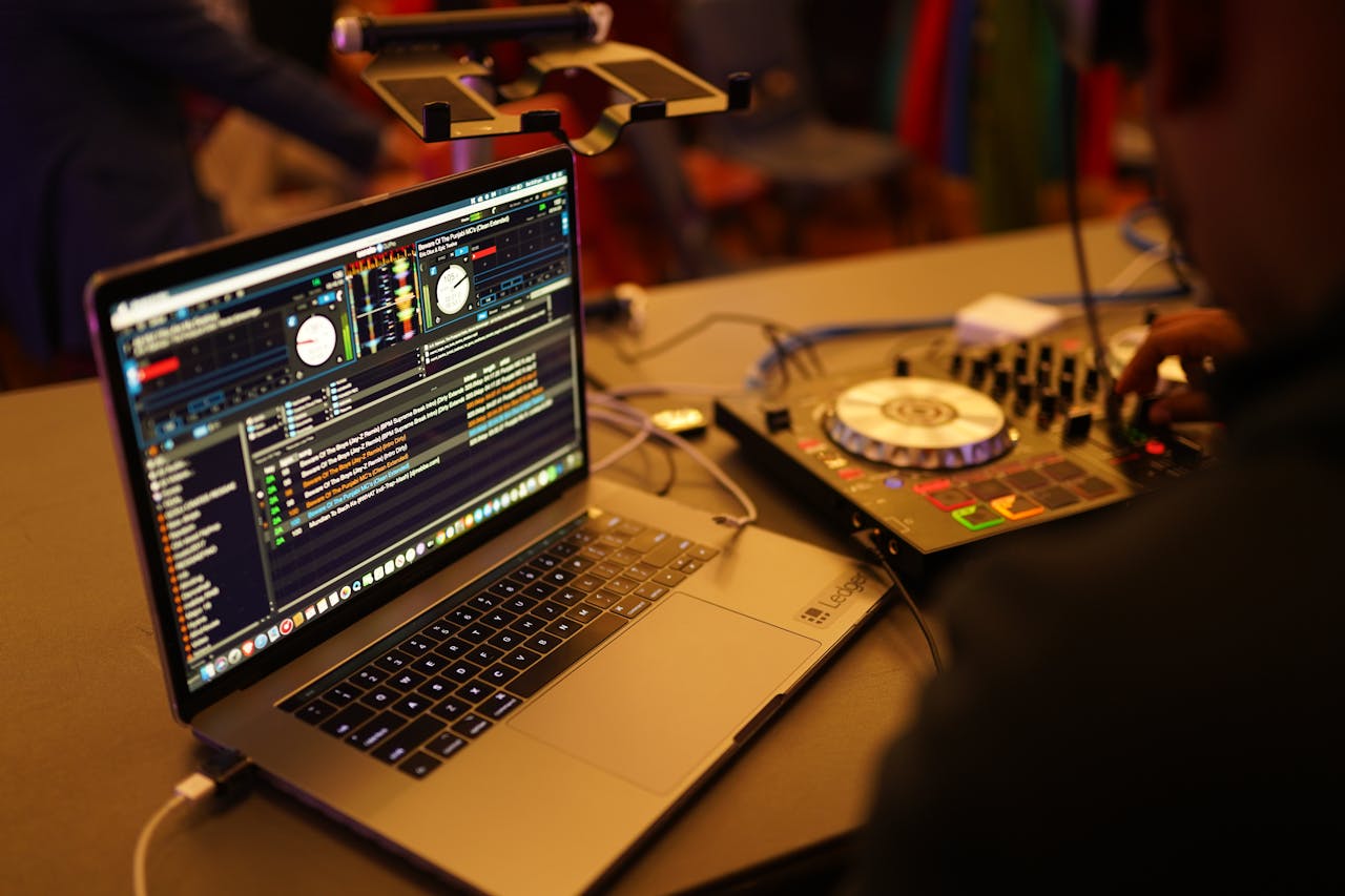 services-bg Close-up shot of a DJ setup featuring a laptop and audio mixer, ideal for music events.